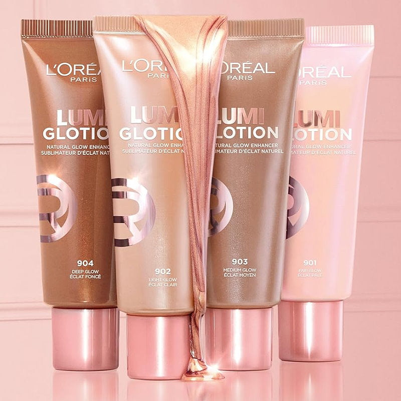 Four L'Oreal Lumiglotion tubes in different shades on a pink background