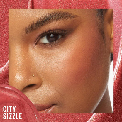 Close-up of a person's face with a red lip product labeled 'City Sizzle' on a red background