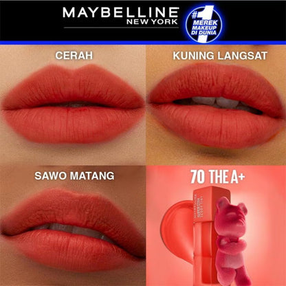 Maybelline New York lip color swatches with product packaging on a brown background